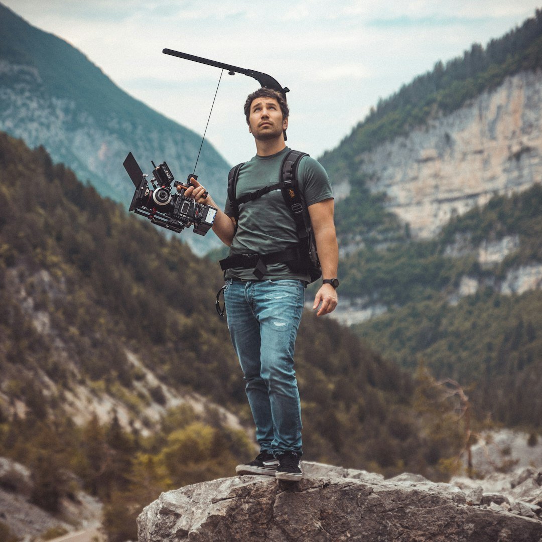 Italian male camera operator holding a professional video camera